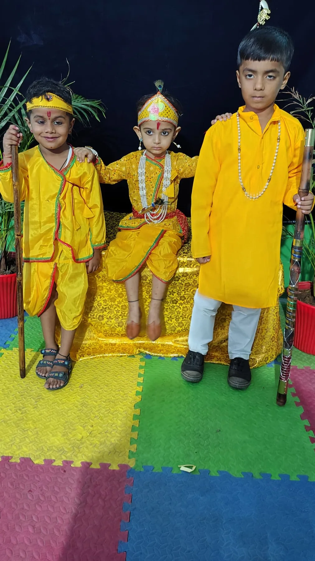 Three Science Academy students in Janmashtami costumes