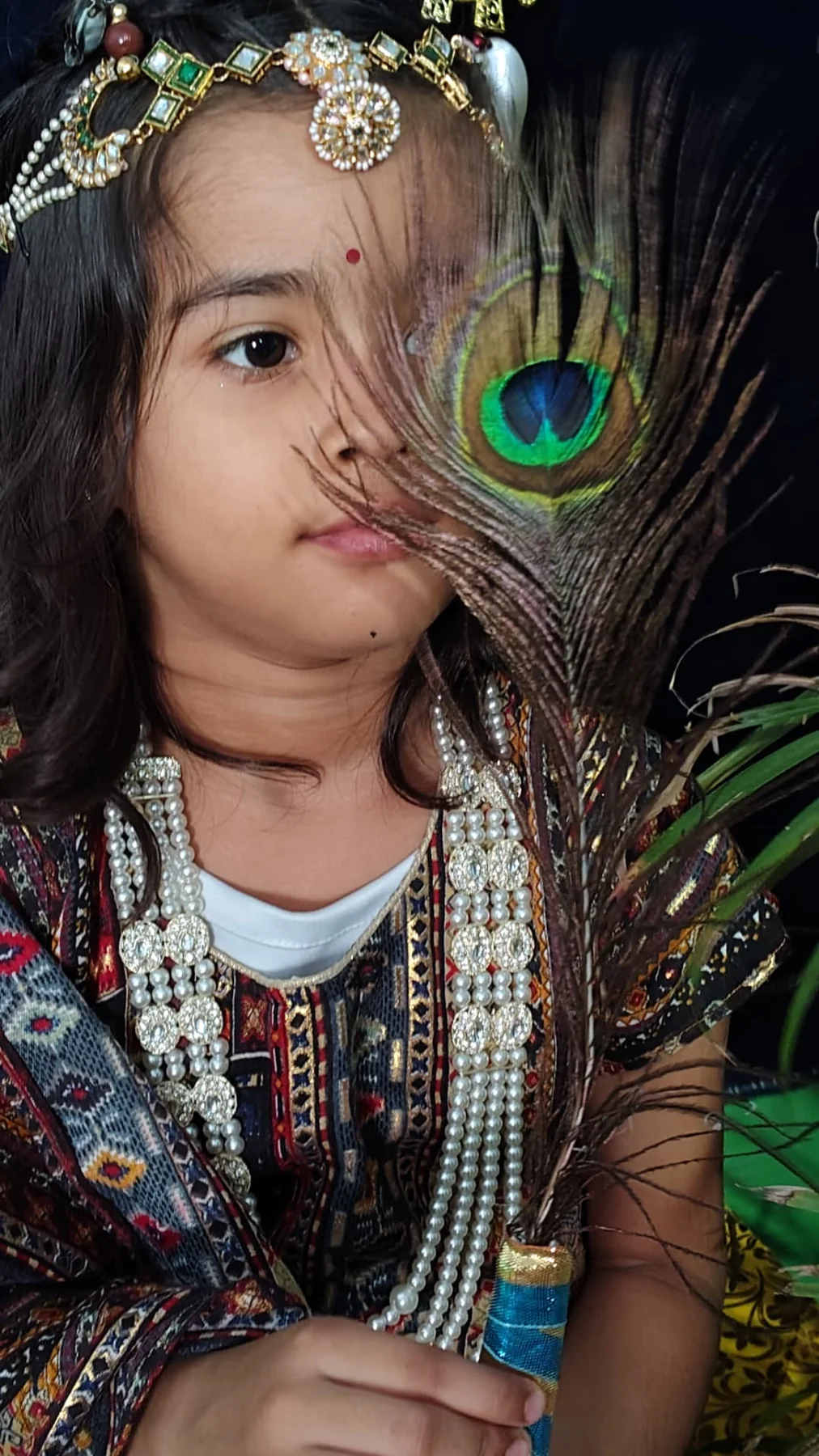 Science Academy student holding a peacock feather