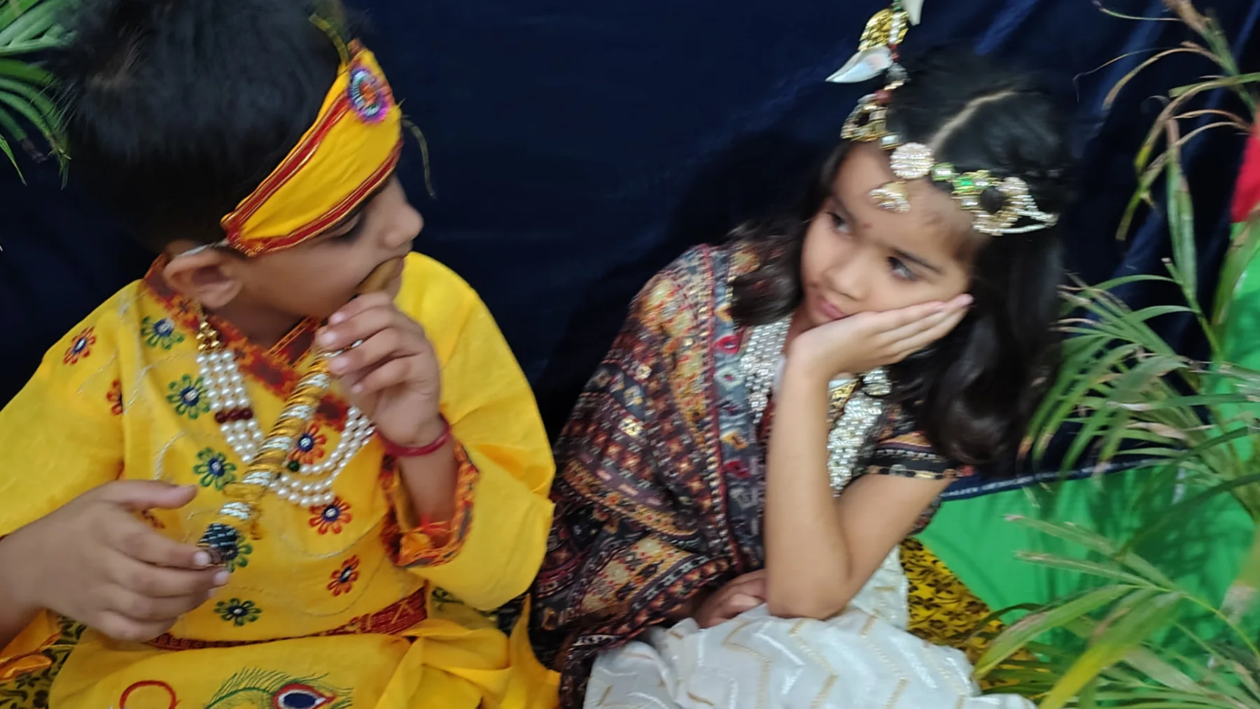 Two students sharing a Janmashtami performance moment