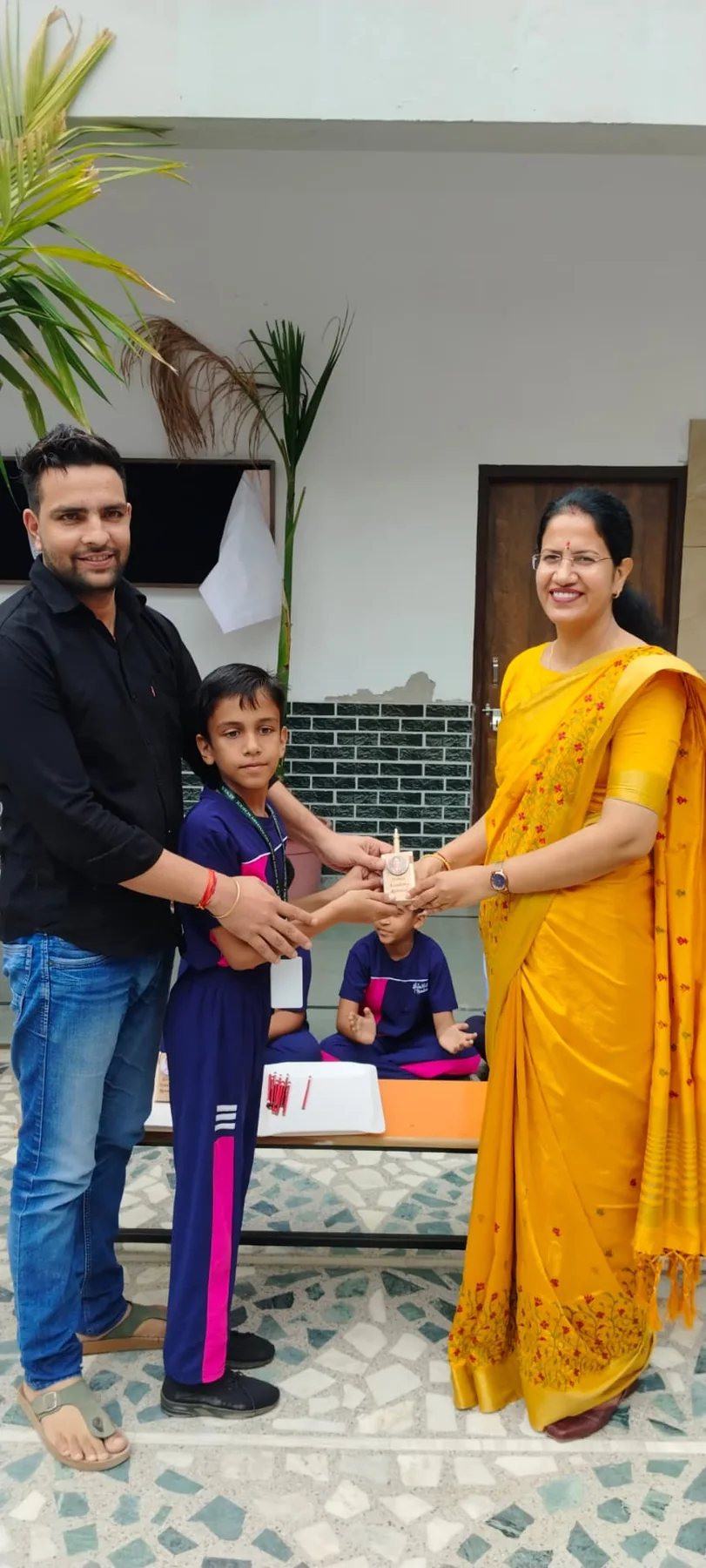 Science Academy teacher presenting an award to a student